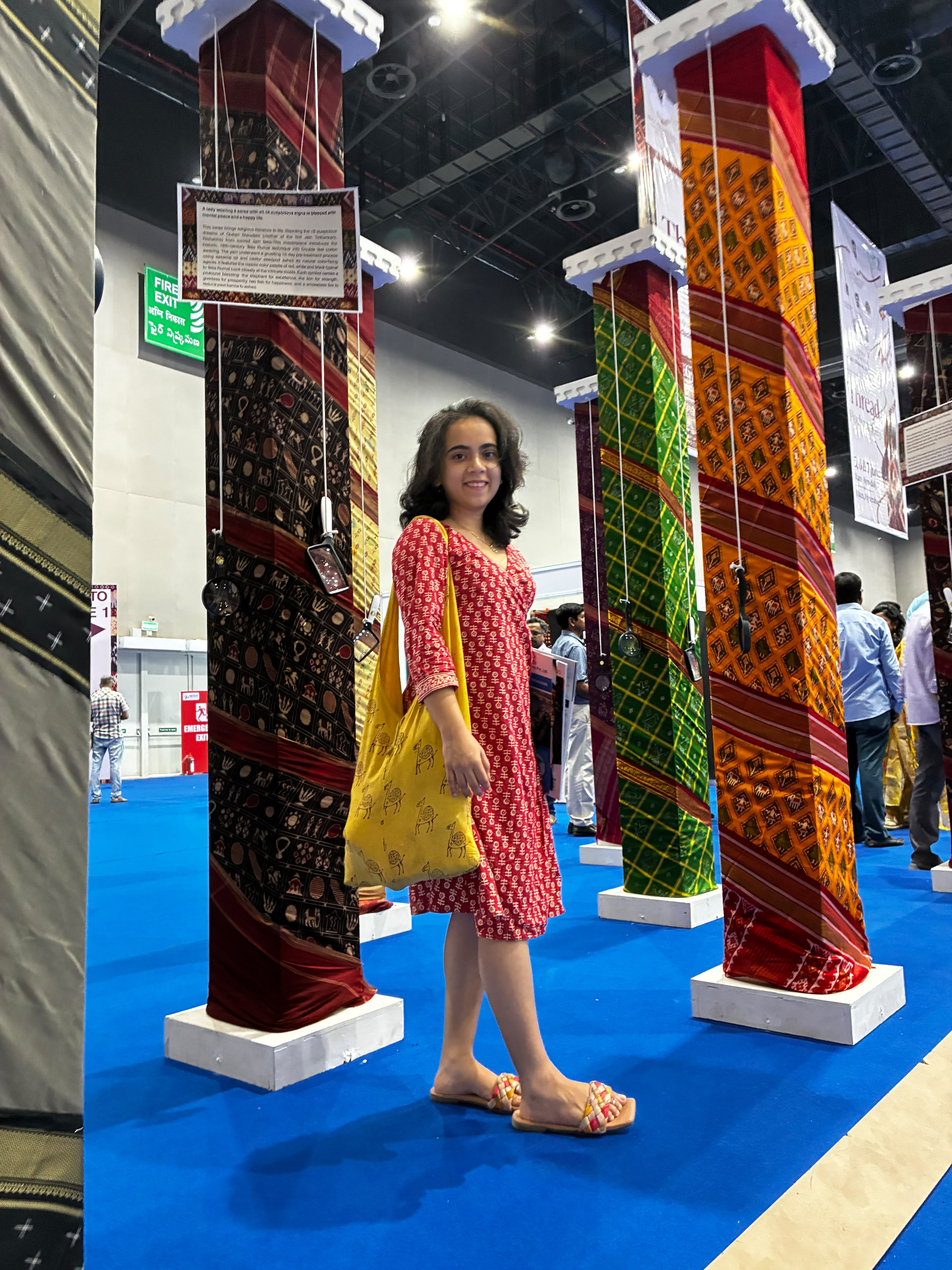 Exhibition pillars wrapped in traditional block-print and ikat fabrics